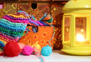 Beautiful phot with knitting and needles and light with a candle cozy atmosphere hobby handmade art design