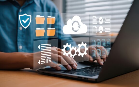 Digital illustration of cloud computing and data management icons floating above hands typing on laptop keyboard, featuring shield, folders, cloud refresh, and gears in soft focus - Powered by Adobe