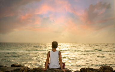 A man gazes at the ocean, lost in the beauty of nature's embrace