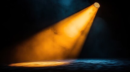 Fototapeta premium Radiant gold spotlight shining from above onto a black velvet stage, casting smooth golden shadows