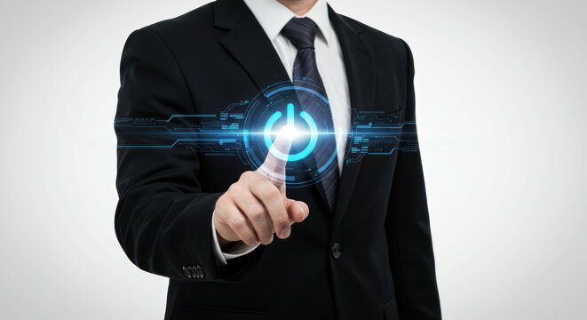 Man in suit presses glowing start button on futuristic interface against gray background.
