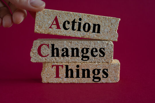 Concept words Action, Changes and Things on brick blocks. Red background. Businessman hand. Symbolizes the process of taking action to implement changes in various aspects of life or business.