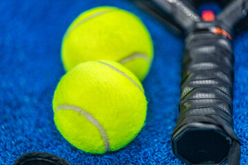Padel tennis racket and balls close-up. Background with copy space. Sport court and ball