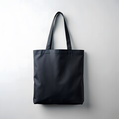 Black canvas tote bag hanging against white background