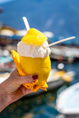 Yellow lemons on cobbled street in Lemonero sul Garda, Italy, with rustic architecture and summer...