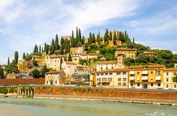 Fototapeta premium Medieval Castello Visconteo in Verona, Italy, featuring fortified brick walls, defensive towers, and a clear sunny sky backdrop