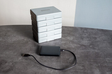 External hard drive with USB cable on desk, ready for connection