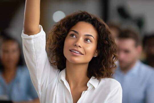 Young african female raising hand in classroom learning environment