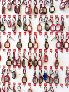 Hanging keys with numbers on a white background in a vintage hotel reception area
