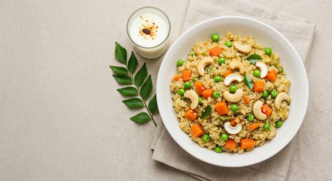 Top-down view of a wholesome bowl of vegetable millet upma served with spiced buttermilk, a vegan meal