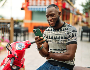 Portrait of a young black man guy talking discussing on smart phone, answeing the phone, having fun...