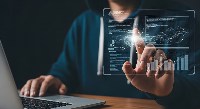 Person in hoodie interacts with holographic data display projected above a laptop, possibly related to technology or security.