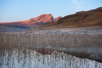 Frosty morning at Loch Cill Chriosd with morning sunlight on Cuillin mountains, Isle of Skye, Scotland, UK.