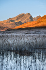 Golden morning sunlight on Red Cuillin mountains on a winter morning on The Isle of Skye, Scotland, UK.
