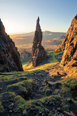 The iconic Needle rock pinnacle with golden morning light near the Quiraing on the stunning Isle of Skye, Scotland, UK.