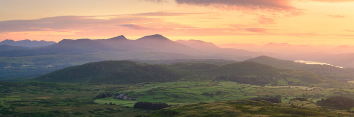 Panoramic view of Coniston mountain range seen from Great Burney on a beautiful summer sunrise,...