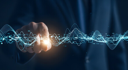 Businessman's hand interacts with abstract digital data waves.