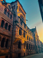 Old architectural building in city against blue bright sky. Cityscape