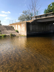 Picturesque river under a bridge on a sunny day