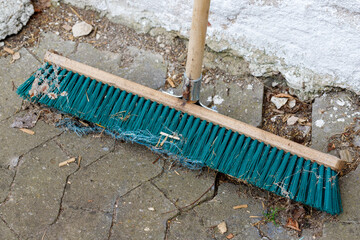 Teal Push Broom on Cracked Concrete Patio