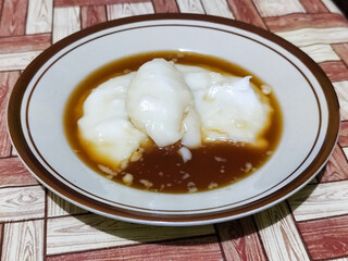 Bubur sumsum, traditional Indonesian food. Soft white marrow porridge served on a plate sprinkled...