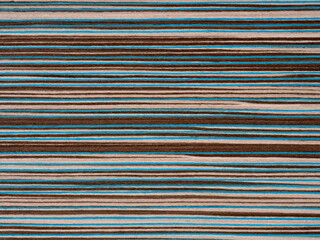 Designer's veneer surface with vibrant teal and rich brown stripes creating a bold contrast