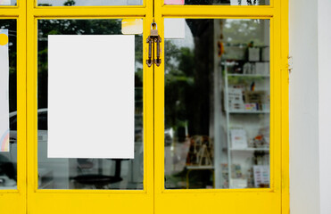 Mockup of white paper poster displayed outside a restaurant or cafe building. Marketing and business concept.