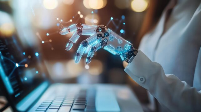 Futuristic robot hand working on a laptop