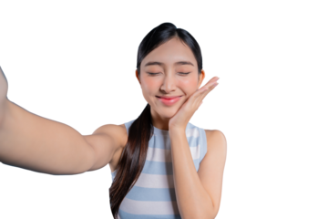 A serene young Asian girl taking a selfie with her eyes closed, gently touching her cheek with a peaceful smile.on png background
