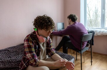 Cozy study session in a pastel-colored room with friends engaging in different activities