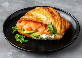 Fresh homemade croissant salmon sandwich with chopped avocado and creamy cheese in black plate on restaurant table.Macro.AI Generative.