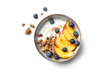 Granola bowl with greek yogurt, peach and blueberries isolated