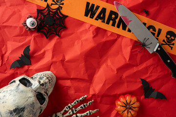 Creepy and festive Halloween setting featuring a skull prop, bats, spider decor, and colorful...