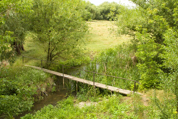 A wooden bridge over a stream