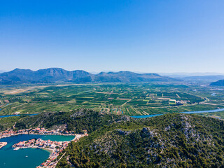 Obraz premium Fertile Neretva River Delta and coastal village of Blace, Croatia – lush green fields, Adriatic sea