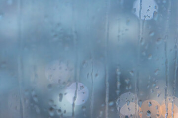 Abstract background of raindrop running down on window with bokeh, copy space