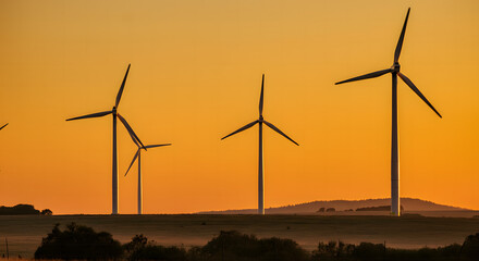 Wind turbines harness renewable energy, transforming the sunset landscape into a green power farm