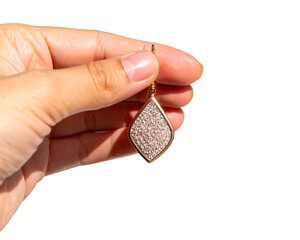 Woman's hand holding a pearl necklace, with fingers gently grasping a coin, a close-up concept of beauty isolated on white