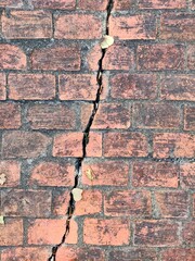 Crack in red brick wall