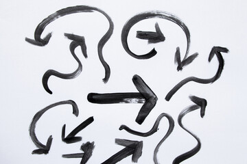 Set of black arrows painted with watercolor, different shapes, directions and curves on white...