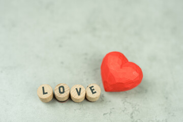 Fototapeta premium A message of LOVE and shape wood vibrant red hearts. Copy Space. Valentine's Day Background.