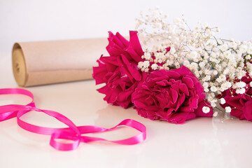 bouquet of roses is being collected on table in flower shop. Valentine's Day. An atmosphere of creativity and inspiration.