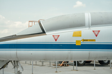 Detailed view of aircraft's cockpit and side panel with visible warning signs. The image focuses on...
