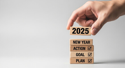 2025 New Year resolution, goal, plan, action, human hand placing wooden block with text.