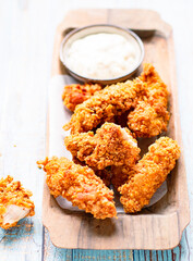 Cornflake Chicken Tenders on a plate with mayonnaise sauce