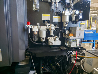 Complex machinery in an industrial facility showcasing control systems and hydraulic components during daytime operations