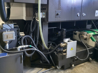 Equipment operation in industrial setting with hydraulic and electrical systems in focus