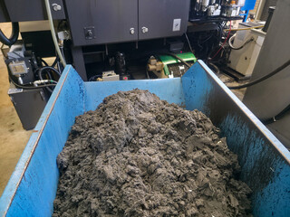 Industrial waste material pile in factory during processing of raw materials for manufacturing...