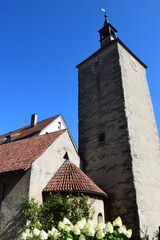 Old church tower in Lindau with flowers in front