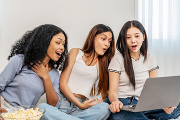 Three asian close friends woman relax on the bed, Girls is sharing popcorn and laughter as they...